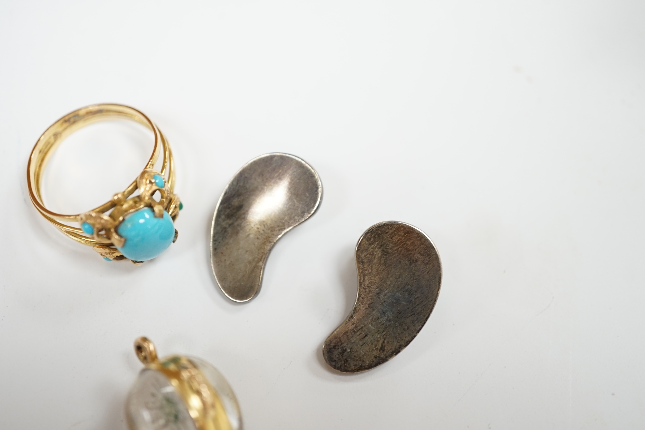 A Middle Eastern yellow metal and turquoise cluster set ring, size P/Q, together with a yellow metal and Essex crystal style egg shaped pendant, depicting a flower and a pair of Georg Jensen sterling ear clips, design no